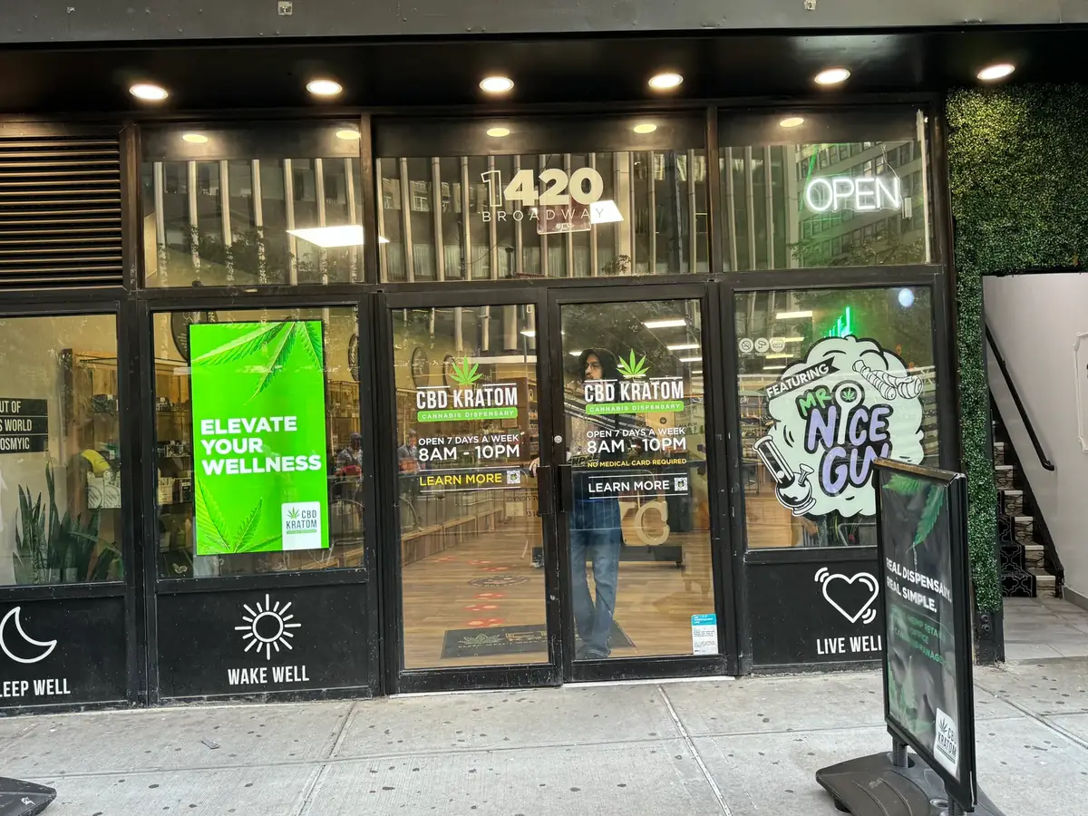 CBD Kratom storefront digital sign: a portrait Samsung OM55B behind the glass