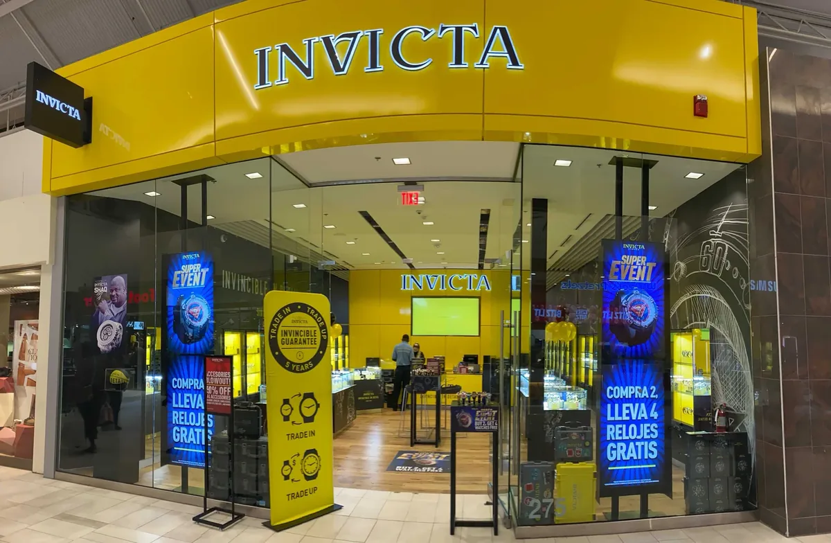 Invicta mall storefront with portrait digital displays behind the glass