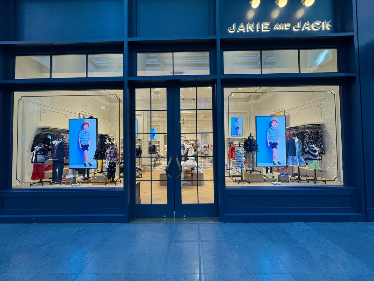 Janie and Jack window with two Samsung OM55B digital window displays on floor stands